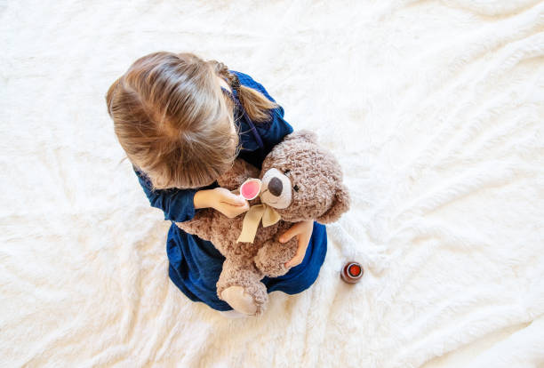 istock High Angle View Of Girl Playing With Teddy Bear 1413663331