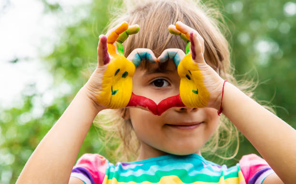 istock Girl Making Heart Gesture With Painted Hands 1413663370