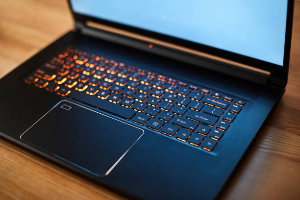 istock Laptop keyboard with orange neon illumination, backlit keyboard. 1413664163
