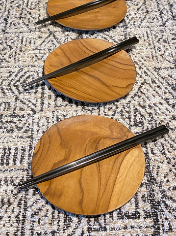 Still life of chopstick and wooden plates on a table top