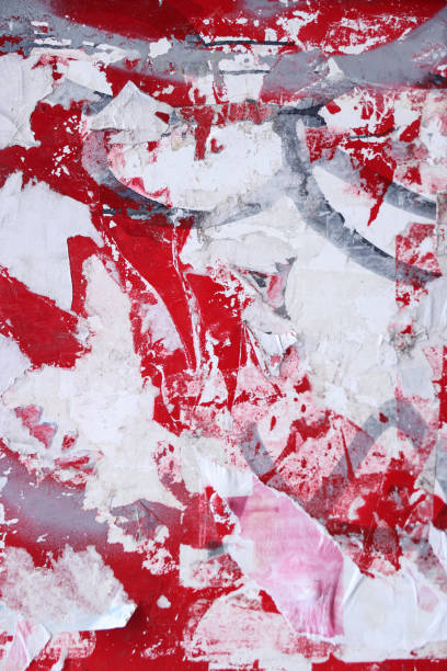 istock Pieces of torn paper peeling off wall used as billboard 1413666007