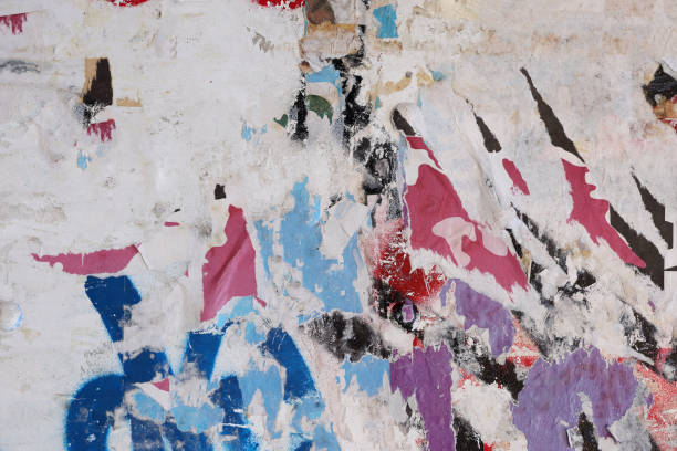 istock Pieces of torn paper peeling off wall used as billboard 1413666090