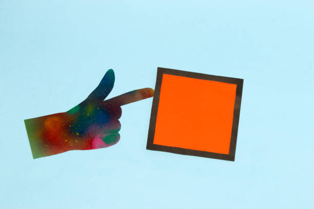 istock abstract art futuristic hand pointing at black-orange frame as copy space, creative art design on blue background 1413666638