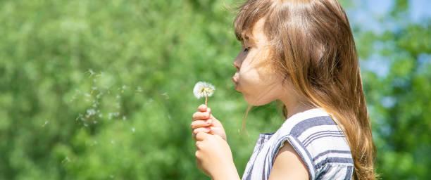 istock Young Woman Blowing Bubbles 1413667615