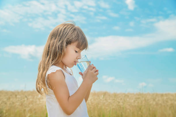 istock Young Woman Drinking Water Against Sky 1413668913