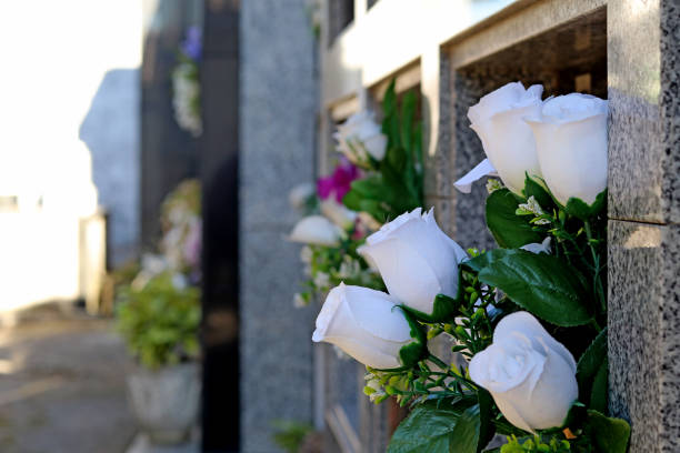 Flowers in niches of a cemetery Flowers in niches of a cemetery undertaker stock pictures, royalty-free photos & images