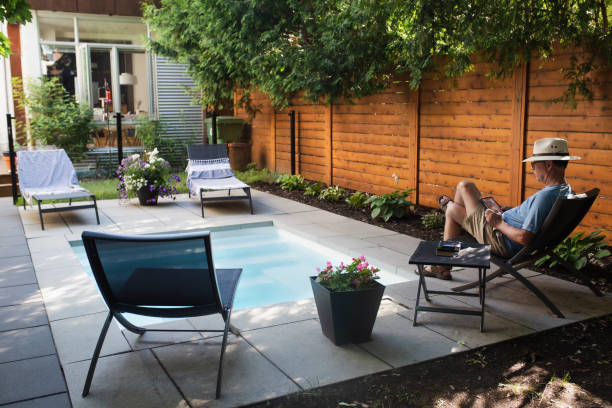 istock A man reading in his back yard by the pool 1413672238