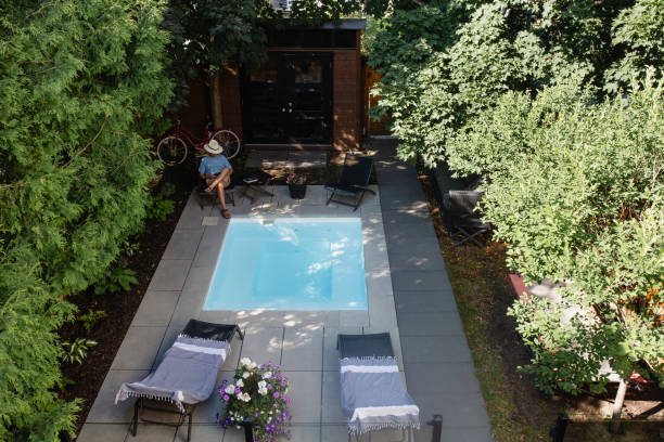 istock A man reading in his back yard by the pool 1413672263