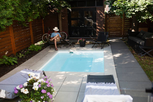 istock A man reading in his back yard by the pool 1413672327