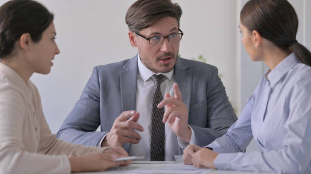 istock Business Person Discussing Documents in Office 1413675174