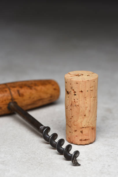 istock Blank Wine Cork with Antique Cork Screw on a gray light to dark background 1413676126