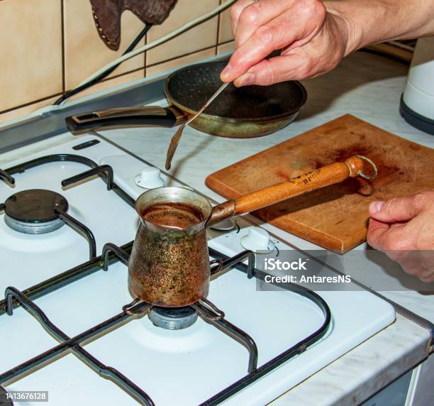 Ground Coffee Is Brewed In A Copper Cezve On A Gas Stove Stock Photo - Download Image Now