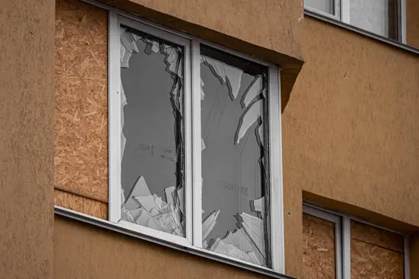 Broken glass. Broken windows of the apartment. The terror of civilians. Russia's war crime. War in Ukraine. Consequences of enemy shelling.