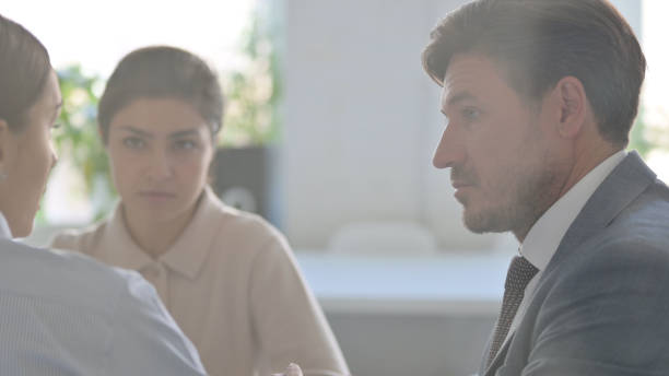 istock Close up of Serious Business People Discussing Work 1413678807