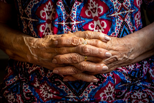 Detail of an elderly woman's hands taken in the living room of her home. Loneliness and depression are just some of the problems that afflict the elderly.