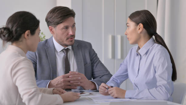 istock Business Person having Serious Discussion in Office 1413682267