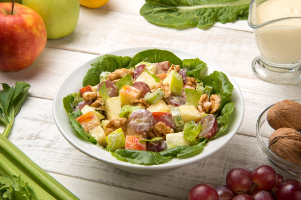 istock Waldorf salad with ingredients on a white wooden table. Selected focus. 1413683532