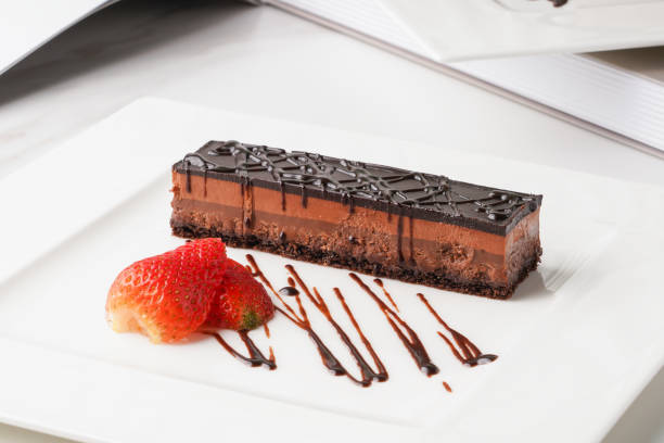 istock chocolate cake with strawberry served in a dish isolated on wooden table side view 1413683681
