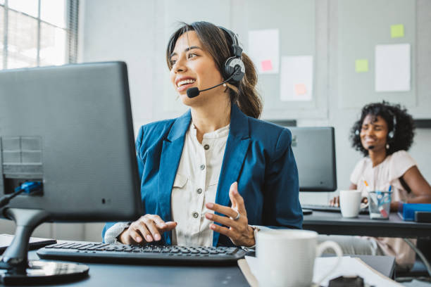 Call center Friendly woman in call center service talking with costumers by headset. Call center and diverse people group in business. prop stock pictures, royalty-free photos & images