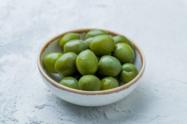 istock large green olives on bowl on white concrete table 1413689041