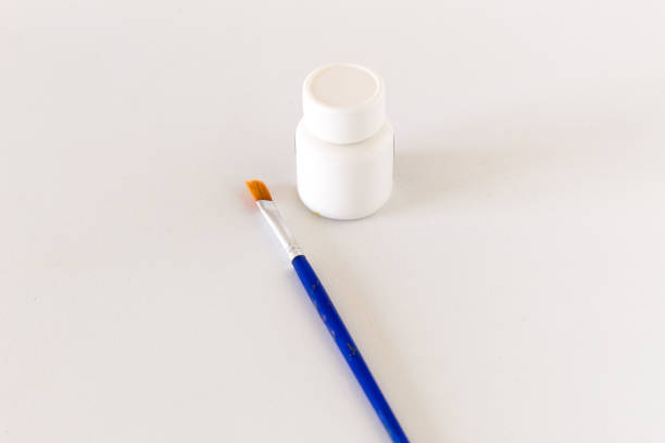 istock White paint and brush isolated on white background. 1413691072