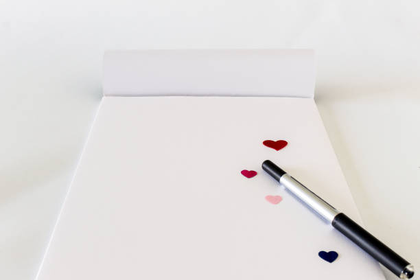 Pen and paper on white background. Copy space.