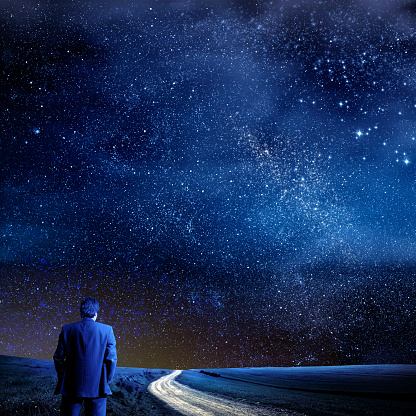 Conceptual businessman over abstract stars of galaxy