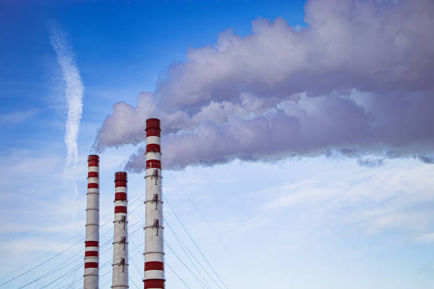 istock Air pollution. Smoking chimneys against blue sky. 1413697341