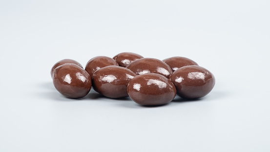 chocolate nuts on gray background, chocolate coated peanuts.