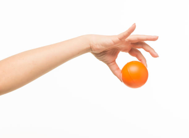 istock female hands holding an orange sponge ball on a white background isolated 1413700839