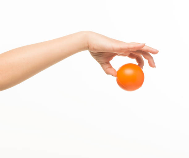 istock female hands holding an orange sponge ball on a white background isolated 1413700852