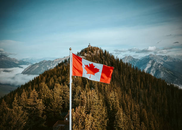 istock Canadian Flag with mountain views 1413703527