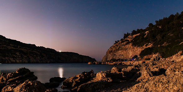 Astrophotography, night sky photo in Anthony Quinn Bay. Landscape photography, traveling concept. Greece, Rhodes, Faliraki region. Water, sea and nature in beautiful famous place. Stars on the long exposure