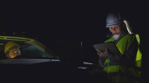 istock High voltage engineers working on the field at night. Sustainable energy. 1413704588
