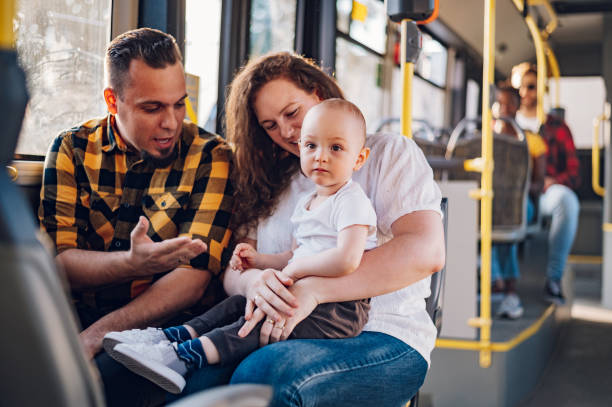 istock Parents riding a bus with their child during a day. 1413705519