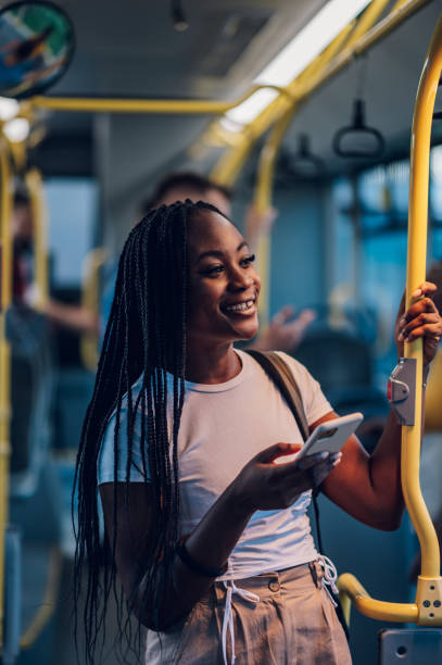 istock African american woman using smartphone while riding a bus in the night 1413705520