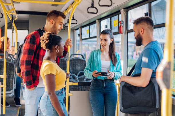 istock Multiracial group of friends talking while riding in a bus 1413705521