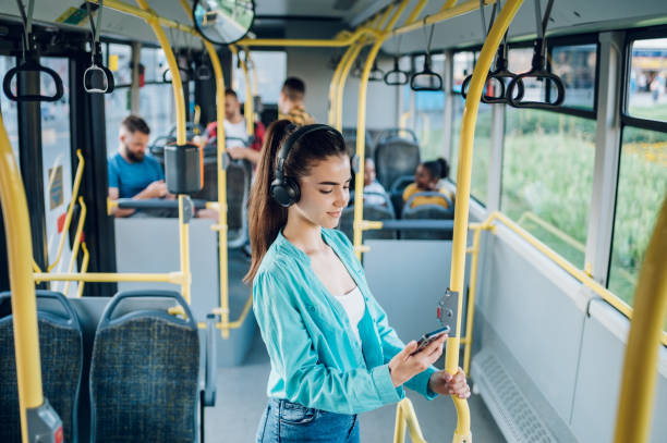 istock Woman paying a bus ticket via smartphone during a ride 1413705523