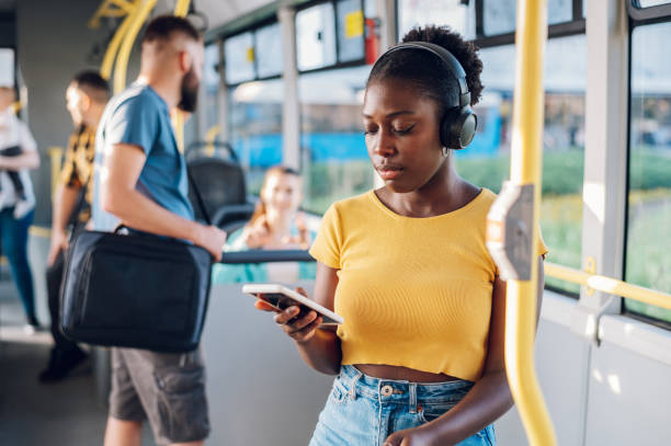 istock African american woman using smartphone while riding a bus 1413705526