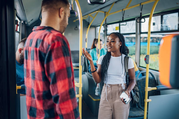istock Multiracial friends talking while riding a bus in the city 1413705527