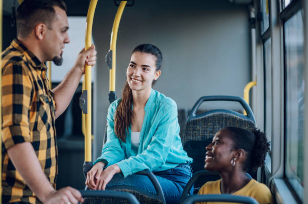 istock Multiracial group of friends talking while riding in a bus 1413705529