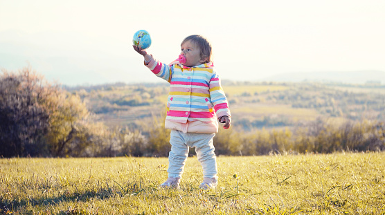 Multi-colored fitget ball connected in the shape of a heart on a white background.