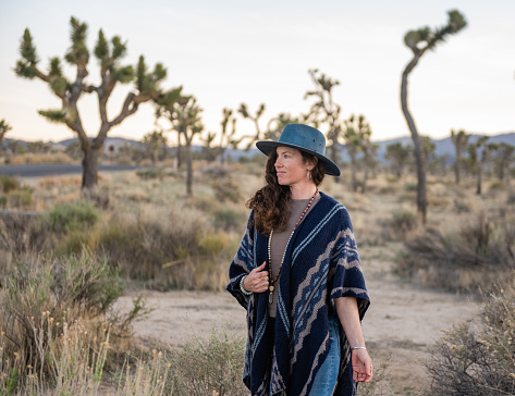 This is a photograph of a 39 year old woman standing outdoors in Joshua Tree National Park on a spring afternoon.
