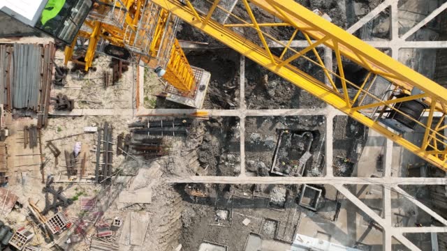 Construction site, cranes and workers. Drone aerial view