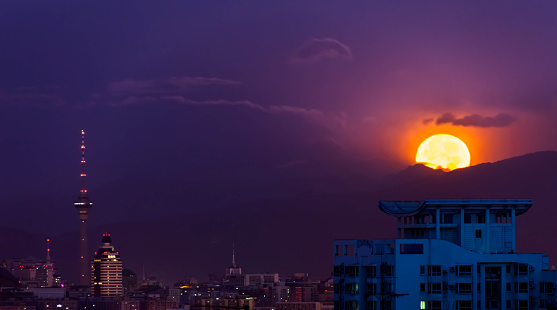 City skyline at night and full moon in Beijing