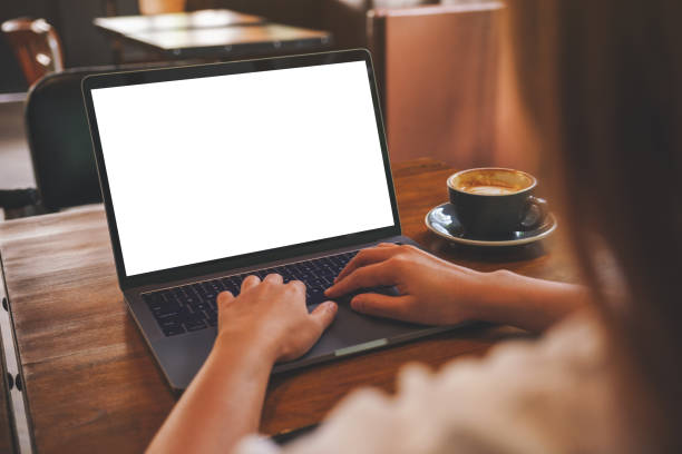 istock Mockup image of a woman using and typing on laptop computer with blank white desktop screen in cafe 1413728867