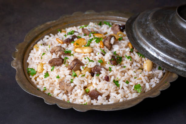 istock Traditional delicious Turkish food; rice pilaf with pine nuts and currants (Turkish name; bademli ic pilav or pilaf) 1413730149