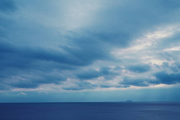istock dark blue sea background, moody sky 1413730673