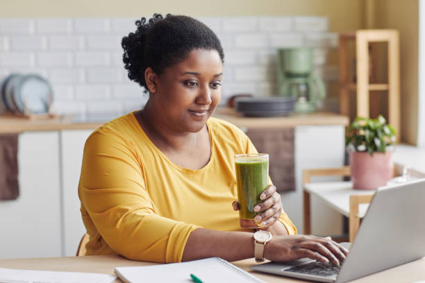 istock Overweight Woman Drinking Smoothie 1413732156