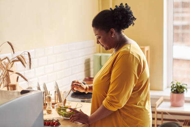 istock Black Woman Cooking in Cozy Kitchen 1413732157